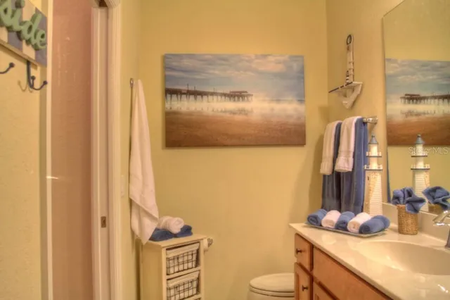 a bathroom with a sink vanity mirror and toilet