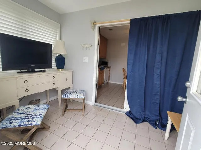 a bedroom with furniture and a flat screen tv