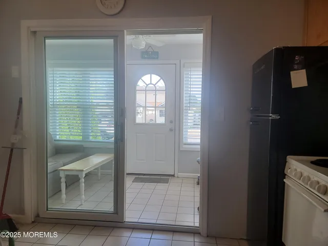 a kitchen with granite countertop lots of wooden furniture a refrigerator a stove top oven and cabinets