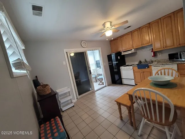 a kitchen with stainless steel appliances a stove a refrigerator and a sink