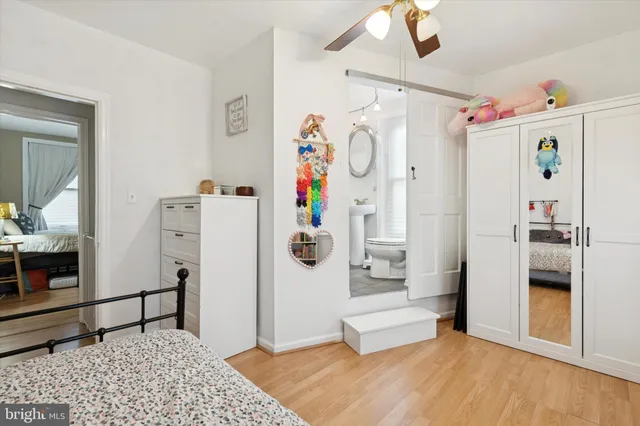 a bedroom with furniture and wooden floor