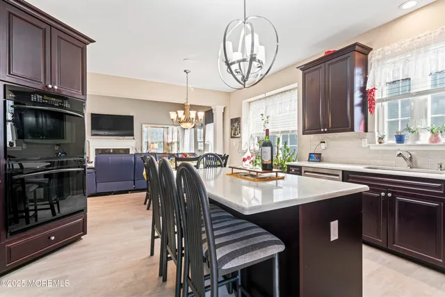 a kitchen with stainless steel appliances granite countertop a sink stove and microwave