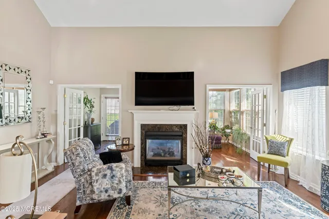 a living room with furniture a fireplace and a flat screen tv
