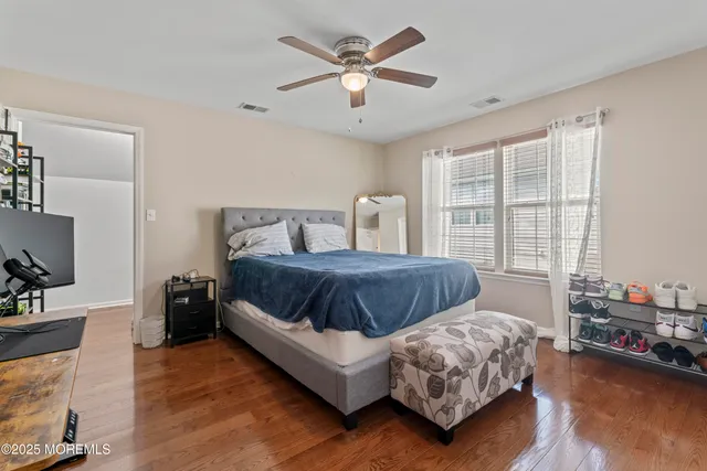 a bedroom with a bed a couch and a large window