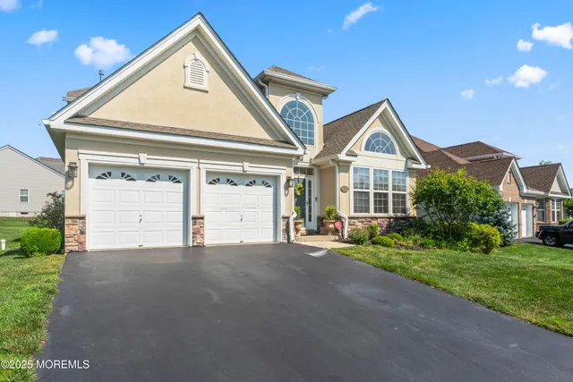 a front view of a house with a yard and garage