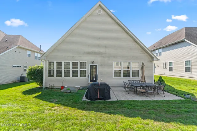 a view of house with backyard and a patio