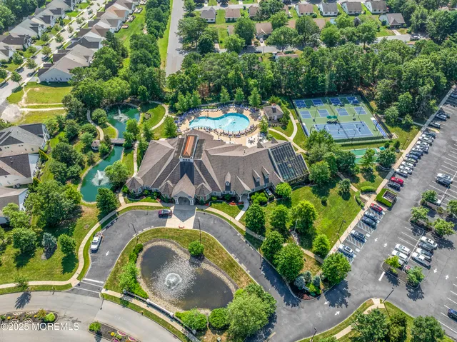 an aerial view of a house with swimming pool and garden view