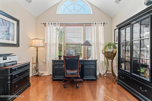 a view of a livingroom with workspace and a window