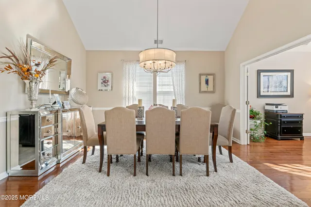 a view of a a dining room with furniture window and wooden floor