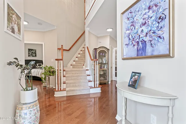 a view of entryway with furniture and wooden floor