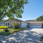 a front view of house with a garden