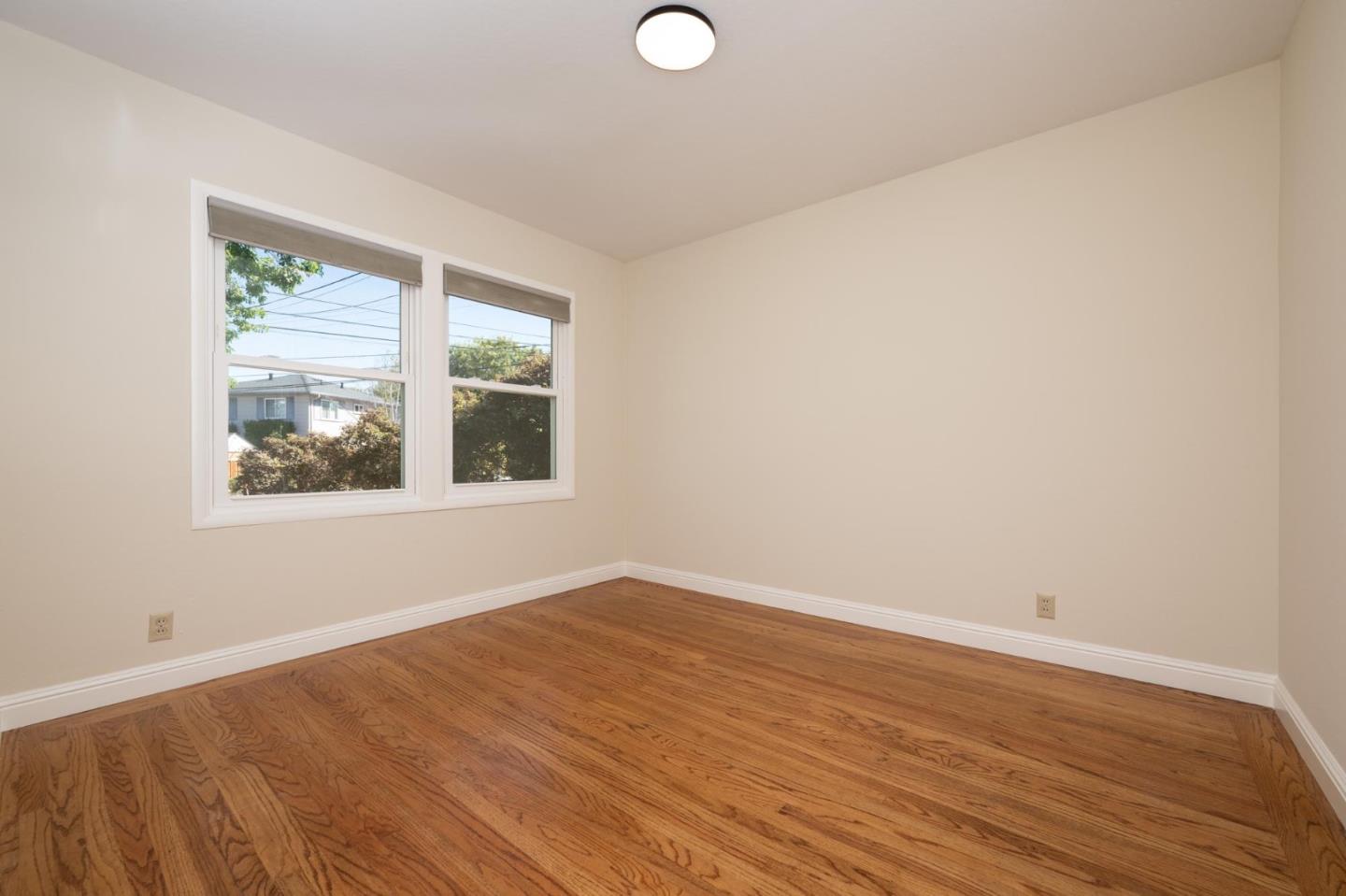 1208 Alomar Way Belmont, CA 94002 - Photo 10 of 18 a view of empty room with wooden floor and fan
