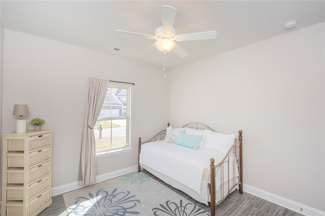 203 Graceview West Anderson, SC 29625 - Photo 17 of 50 This bright and airy bedroom features hardwood flooring and a functional ceiling fan.