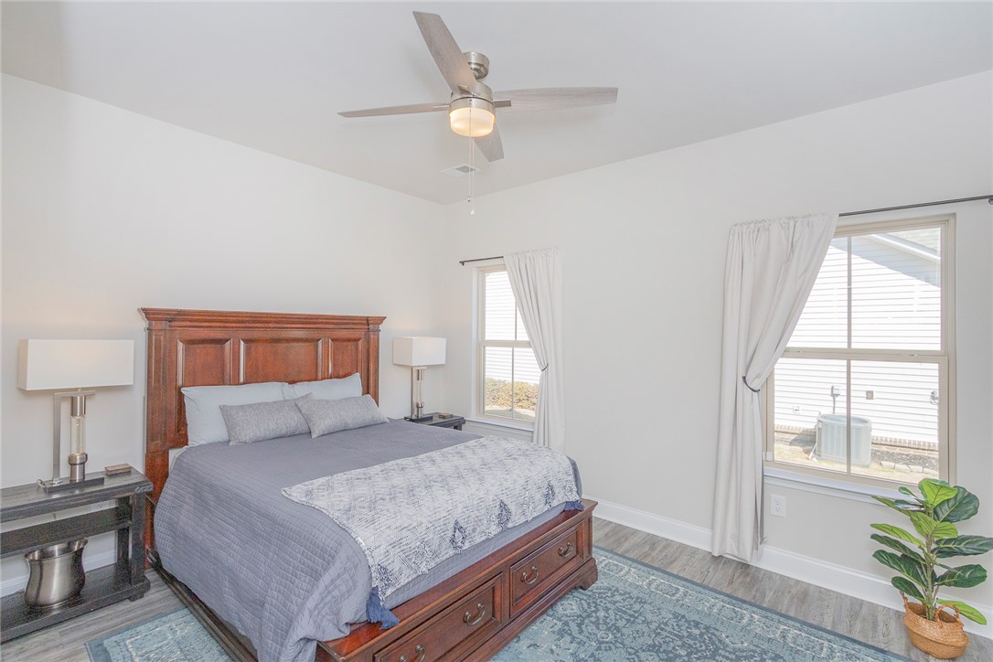 203 Graceview West Anderson, SC 29625 - Photo 19 of 50 This spacious bedroom offers ample natural light and a serene ambiance, perfect for relaxation.
