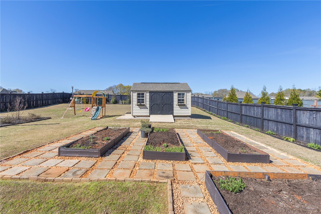 203 Graceview West Anderson, SC 29625 - Photo 40 of 50 This spacious backyard features a storage shed and ample garden space for outdoor enjoyment.