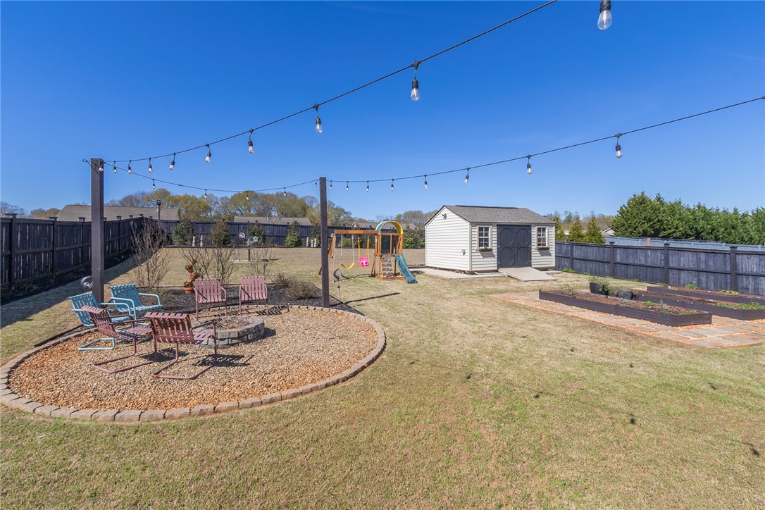 203 Graceview West Anderson, SC 29625 - Photo 41 of 50 Enjoy outdoor gatherings around the fire pit in this spacious, fenced backyard.