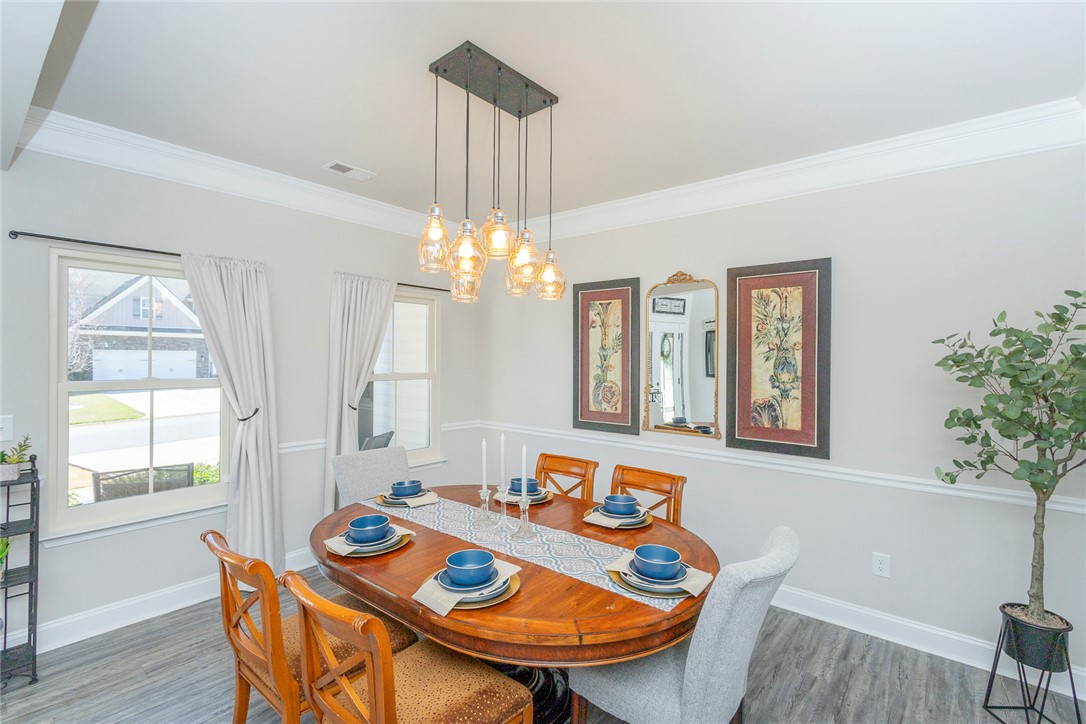 203 Graceview West Anderson, SC 29625 - Photo 5 of 50 This bright dining area offers natural light, modern lighting, and a neutral palette for versatile decor.