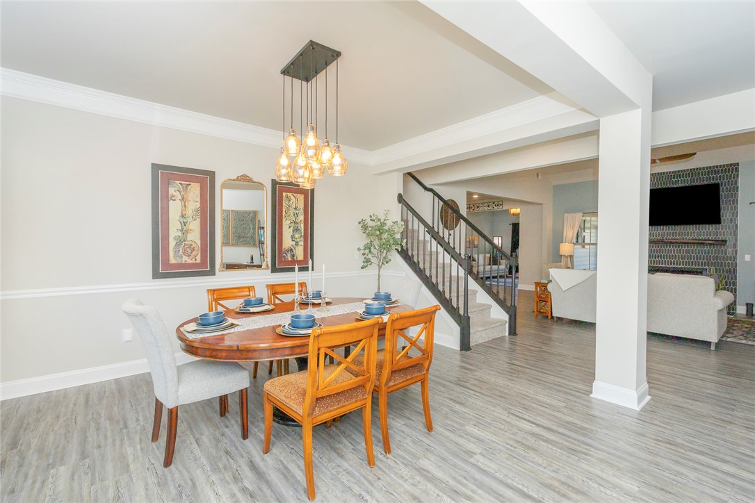 203 Graceview West Anderson, SC 29625 - Photo 48 of 50 This bright dining area features an elegant lighting fixture and an open floor plan, perfect for entertaining.