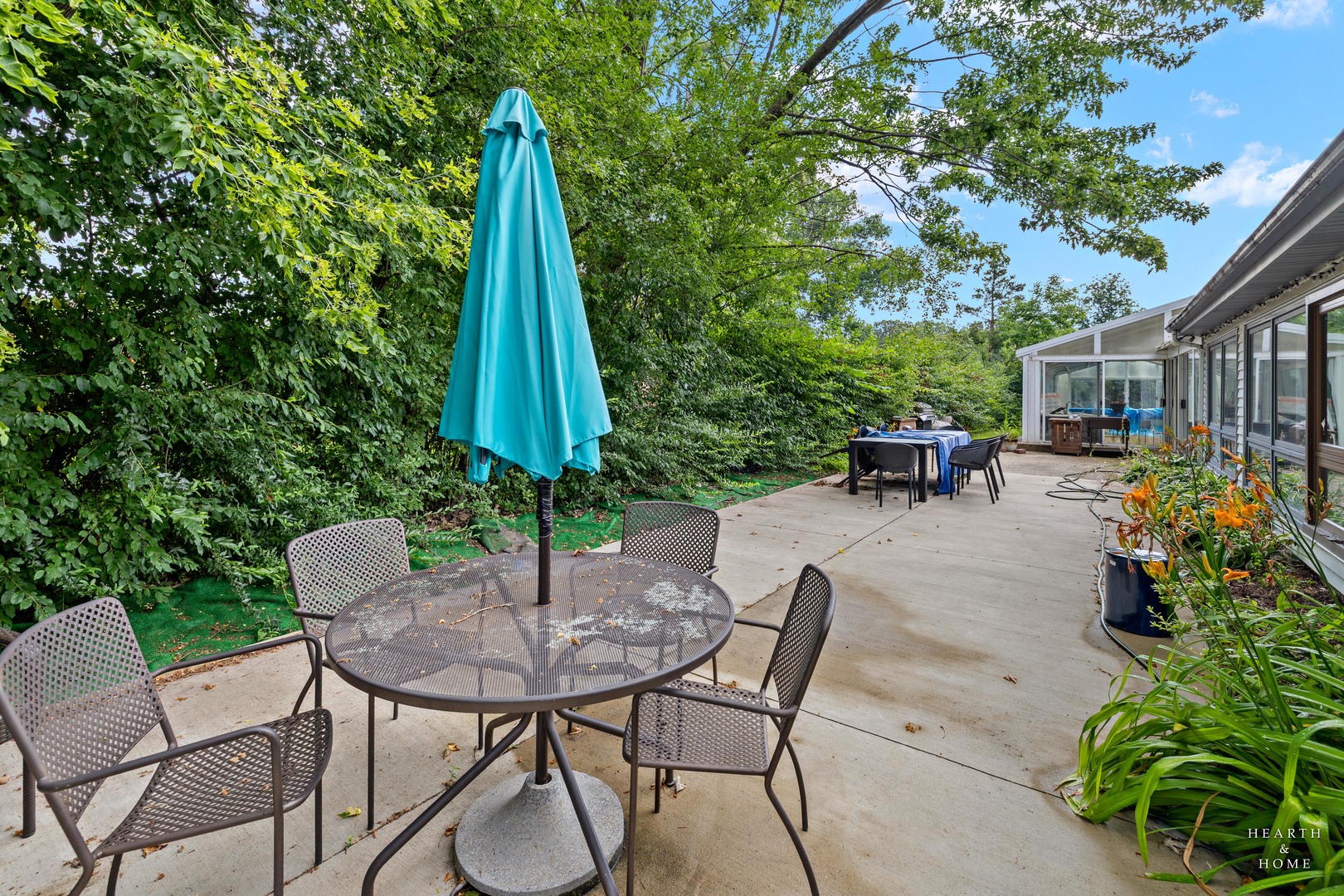 99 Lee Road Northbrook, IL 60062 - Photo 46 of 57 a view of a patio with a table and chairs and potted plants