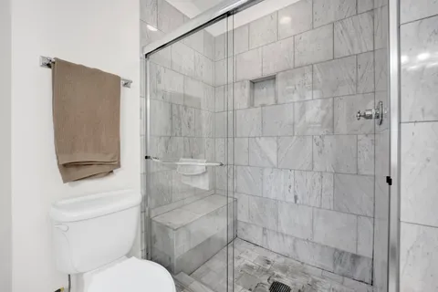 a white toilet sitting next to a bathroom sink