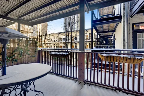 a view of a balcony with furniture