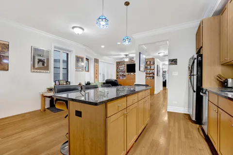 a kitchen with stainless steel appliances granite countertop a sink refrigerator and cabinets
