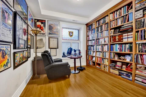 a living room with furniture book shelf and a book shelf