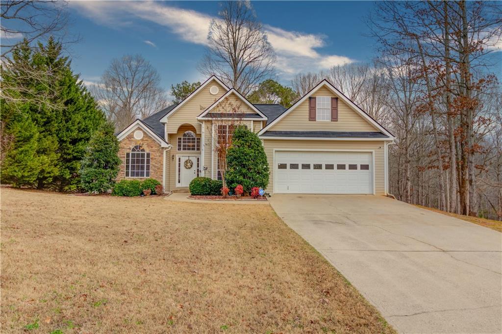 7353 Raleigh Way Bethlehem, GA 30620 - Photo 1 of 1 a view of a house with a yard and garage