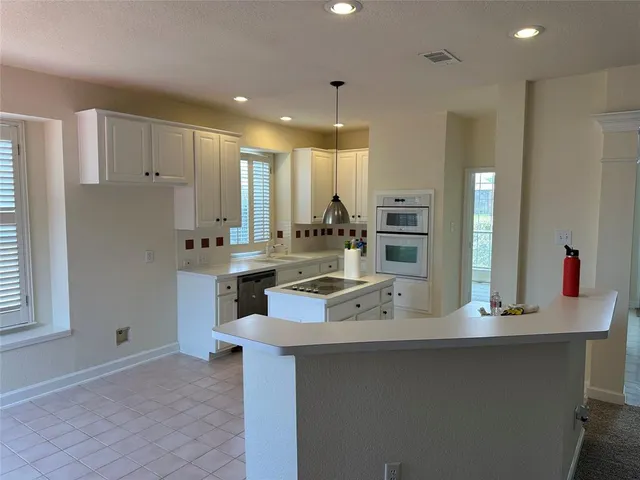 a kitchen with stainless steel appliances a sink stove and cabinets