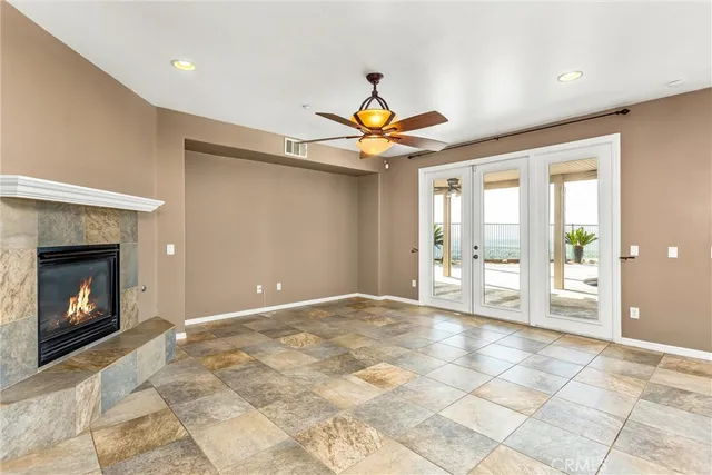 a large kitchen with kitchen island granite countertop a stove top oven a sink a counter space and cabinets