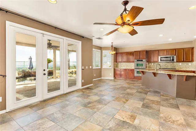 a large kitchen with kitchen island granite countertop a large counter top stainless steel appliances and cabinets