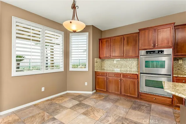 a view of staircase with lots of frames on wall and windows