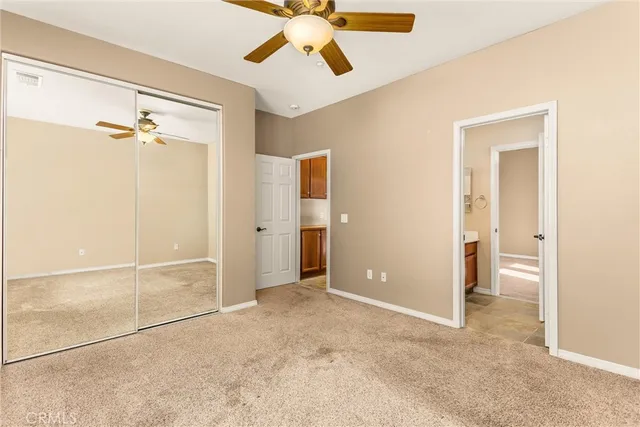 an empty room with a ceiling fan and shower