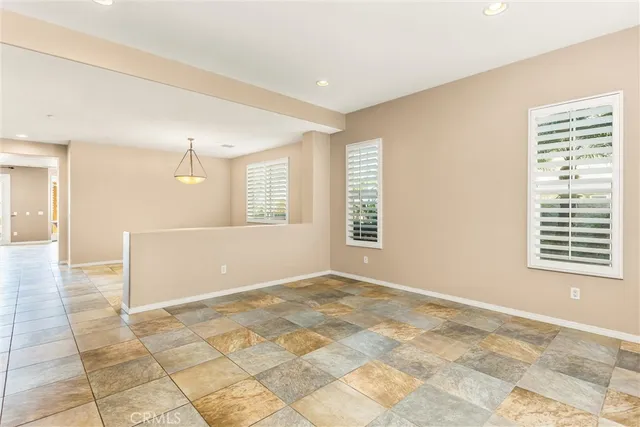 a view of empty room with kitchen appliances and window