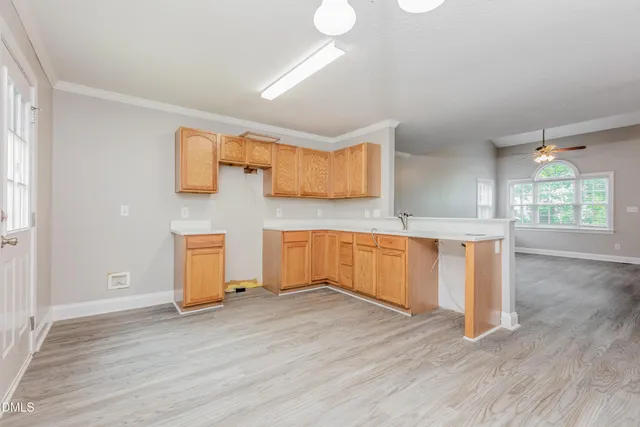 a view of a kitchen with wooden floor and a sink