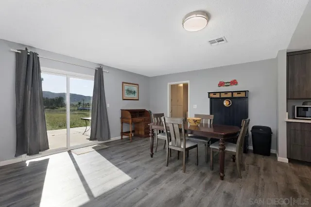 a view of a livingroom with furniture window and wooden floor
