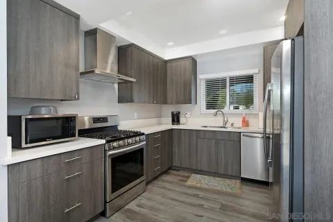 a kitchen with stainless steel appliances a stove a sink and a microwave