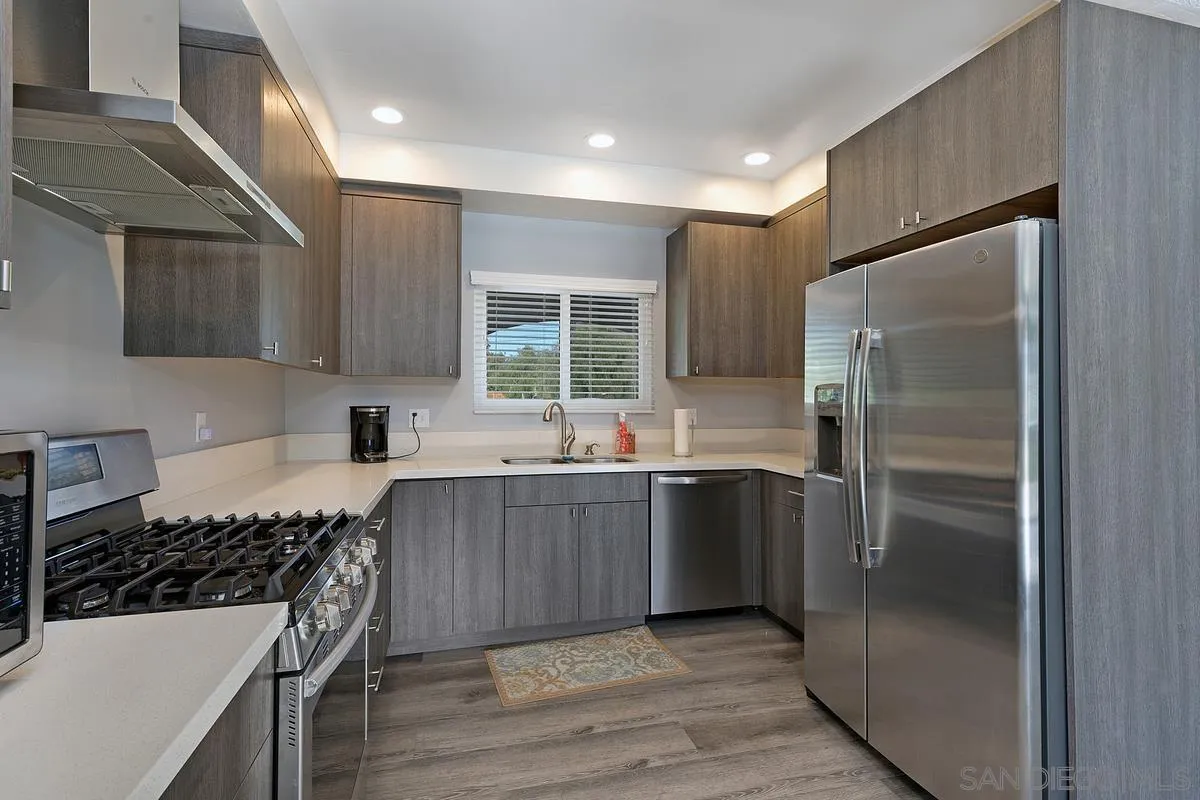 24567 Adams Avenue Murrieta, CA 92562 - Photo 16 of 42 a kitchen with stainless steel appliances granite countertop a refrigerator and a sink