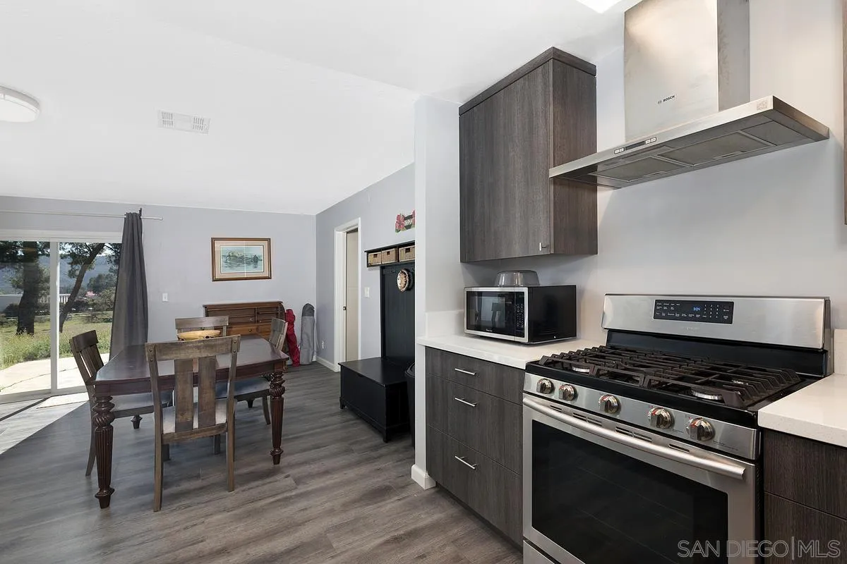 24567 Adams Avenue Murrieta, CA 92562 - Photo 17 of 42 a kitchen with a stove and a refrigerator
