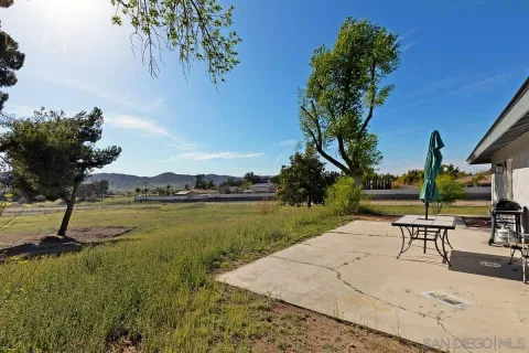a view of a lake with a table and chairs