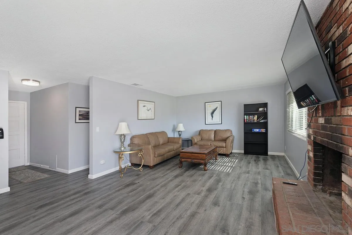 24567 Adams Avenue Murrieta, CA 92562 - Photo 7 of 42 a living room with furniture and a fireplace
