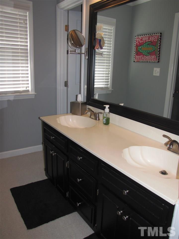 15800 Possum Track Road Raleigh, NC 27614 - Photo 11 of 25 a bathroom with a sink vanity and a mirror