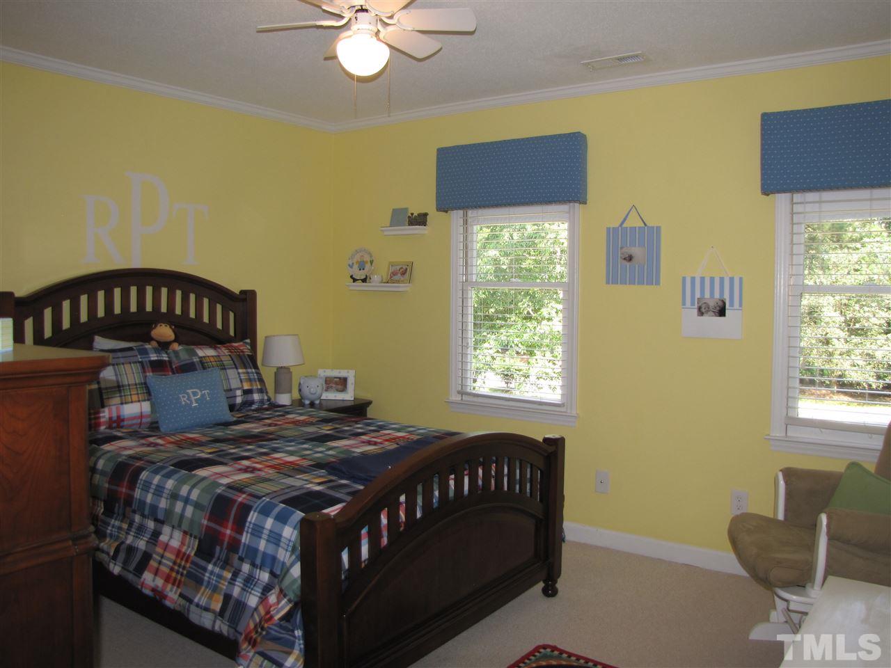 15800 Possum Track Road Raleigh, NC 27614 - Photo 13 of 25 a bedroom with a bed a window and dresser