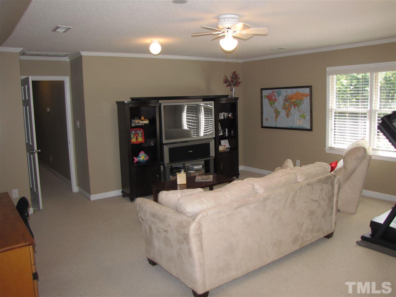 15800 Possum Track Road Raleigh, NC 27614 - Photo 16 of 25 a living room with furniture and a flat screen tv