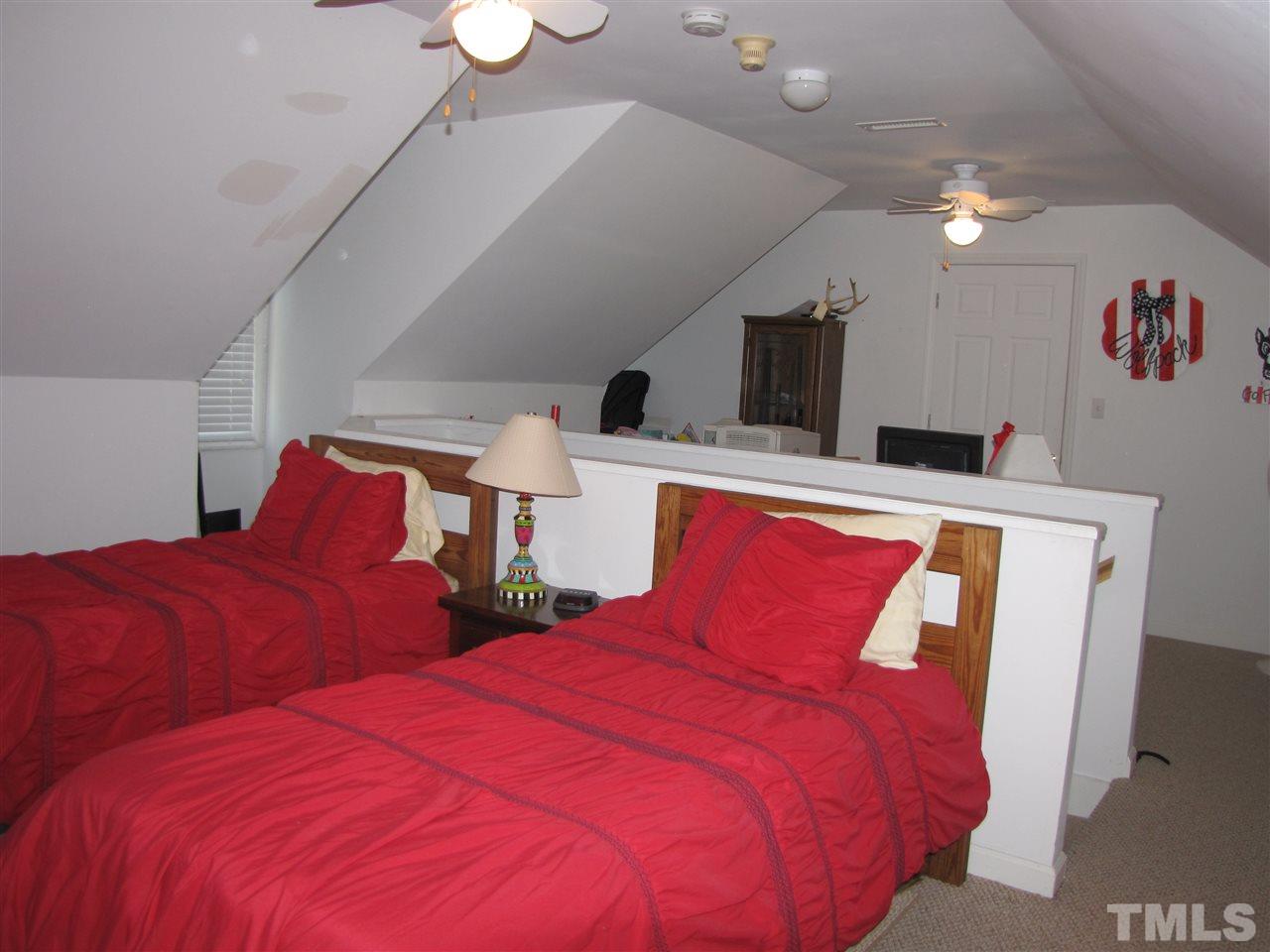 15800 Possum Track Road Raleigh, NC 27614 - Photo 17 of 25 a bedroom with two beds and a chandelier