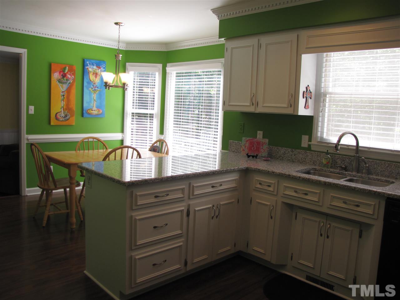 15800 Possum Track Road Raleigh, NC 27614 - Photo 9 of 25 a kitchen with stainless steel appliances granite countertop a sink a stove and cabinets