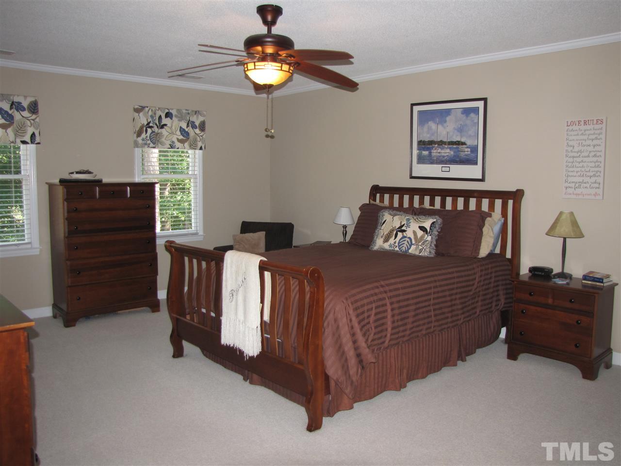 15800 Possum Track Road Raleigh, NC 27614 - Photo 10 of 25 a bedroom with a bed and a chandelier