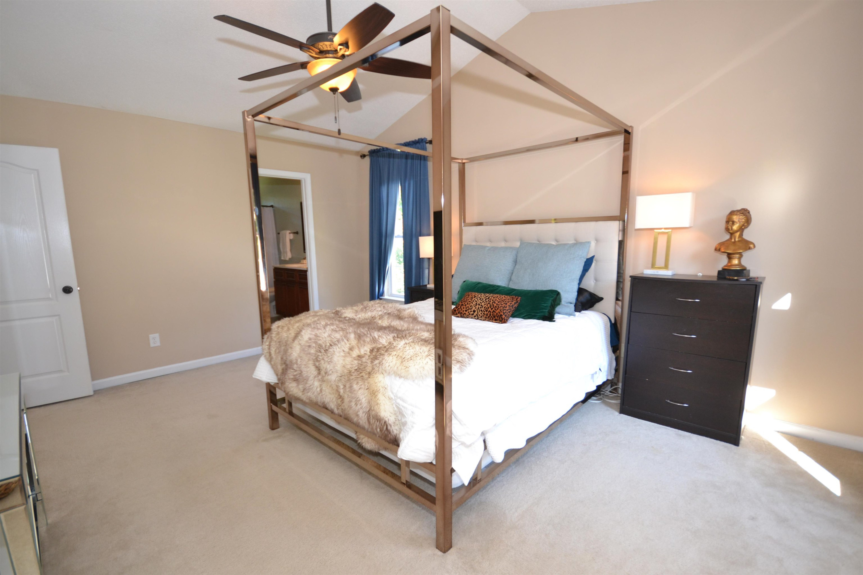 5501 Cardinal Grove Boulevard Raleigh, NC 27616 - Photo 13 of 37 a bedroom with a bed and a chandelier