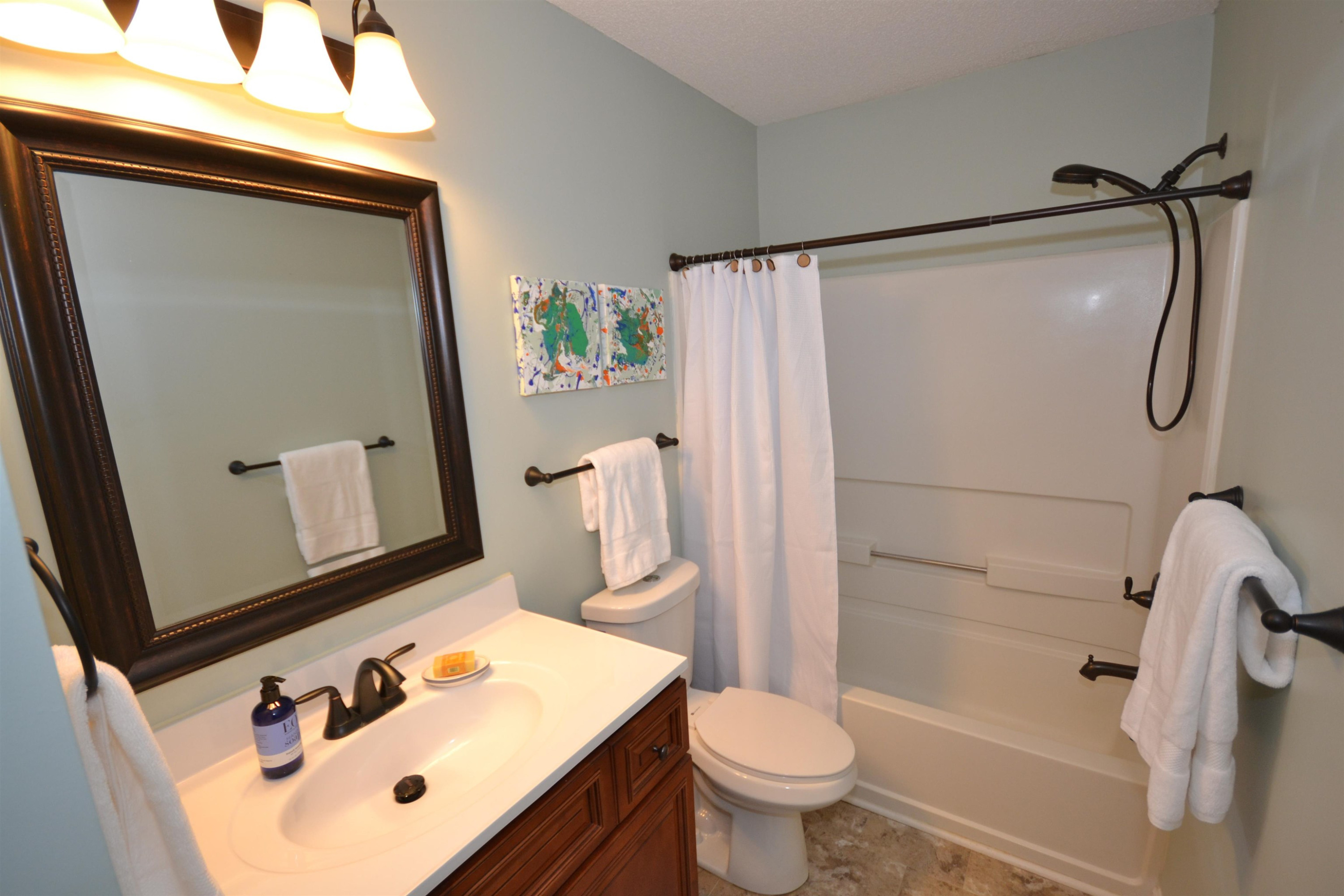 5501 Cardinal Grove Boulevard Raleigh, NC 27616 - Photo 20 of 37 a bathroom with a sink toilet and shower