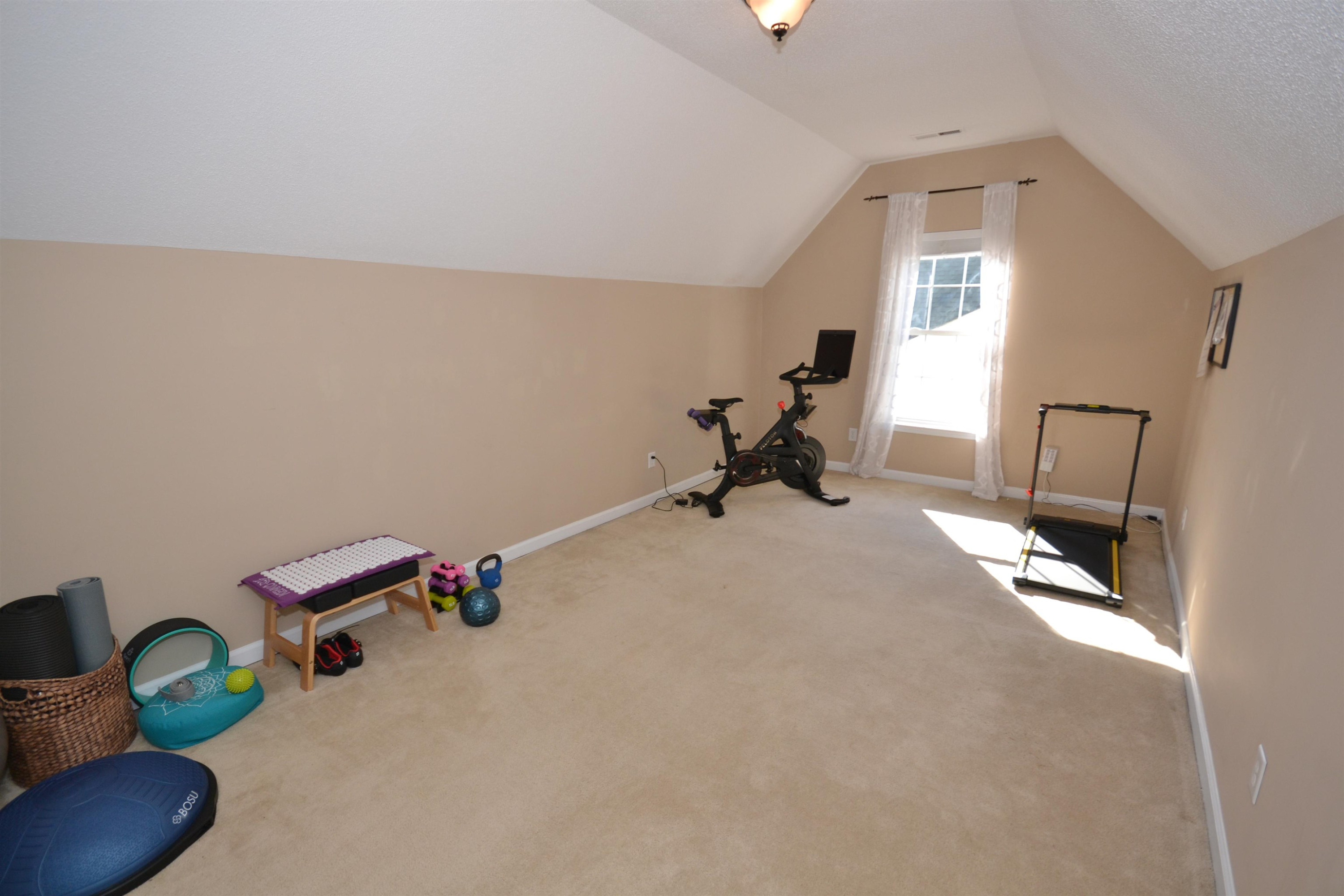 5501 Cardinal Grove Boulevard Raleigh, NC 27616 - Photo 22 of 37 a room with chair and gym equipment